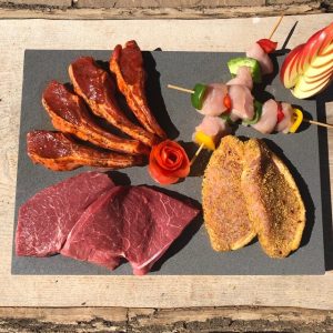 An image of the Perrys Deluxe BBQ pack. Including British beef steaks, pork steaks, lamb cutlets and chicken skewers